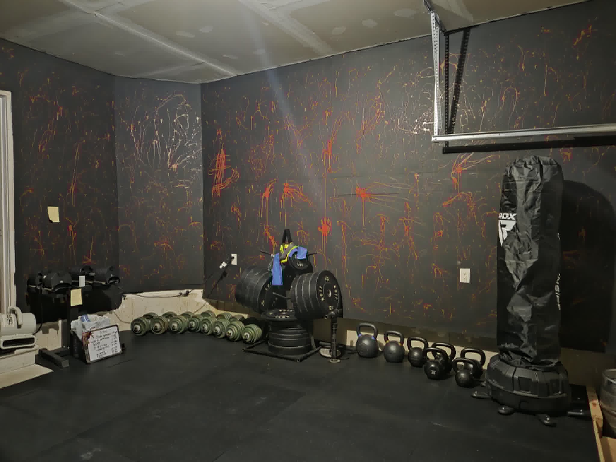 Dumbbells, bumper plates, kettlebells and a heavy bag inside the SWALLFitness studio